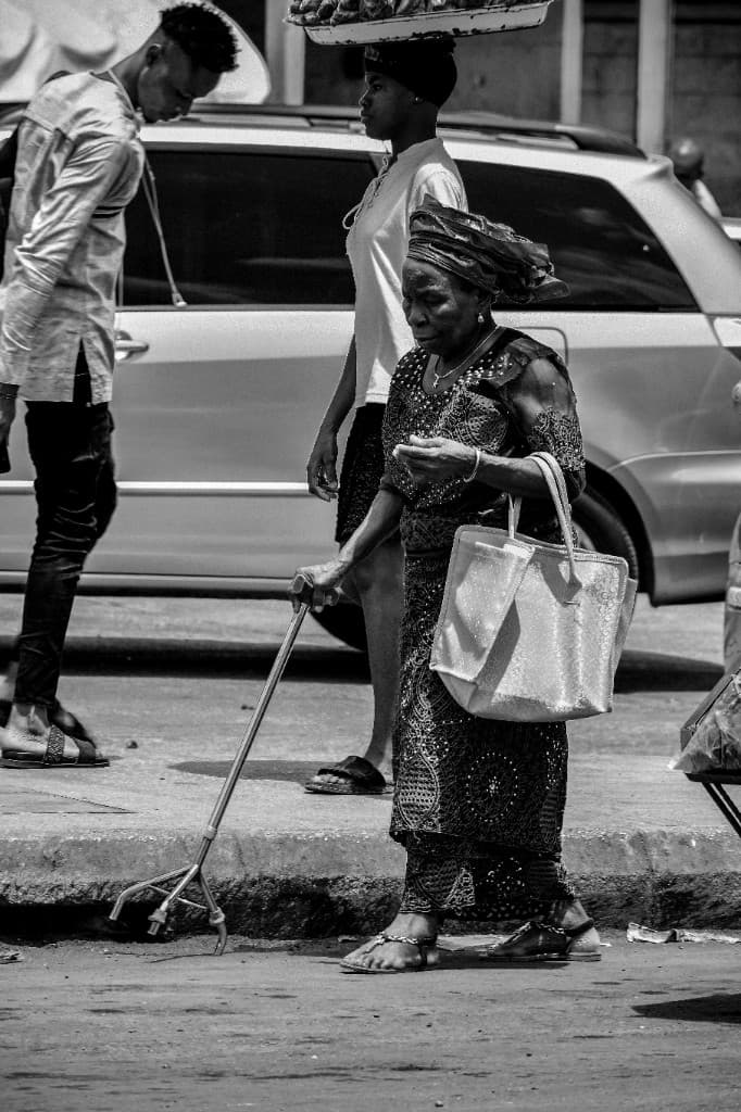 Elderly woman walking through a street market