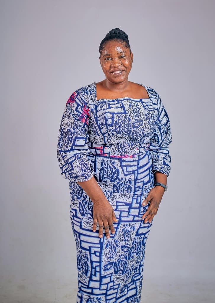 Smiling woman in blue and white Ankara print dress