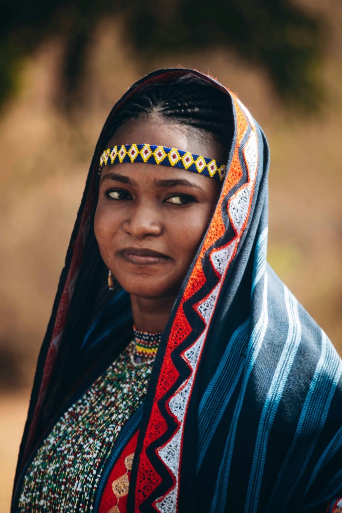 Woman in Maasai beaded collar and patterned headwrap, profile view