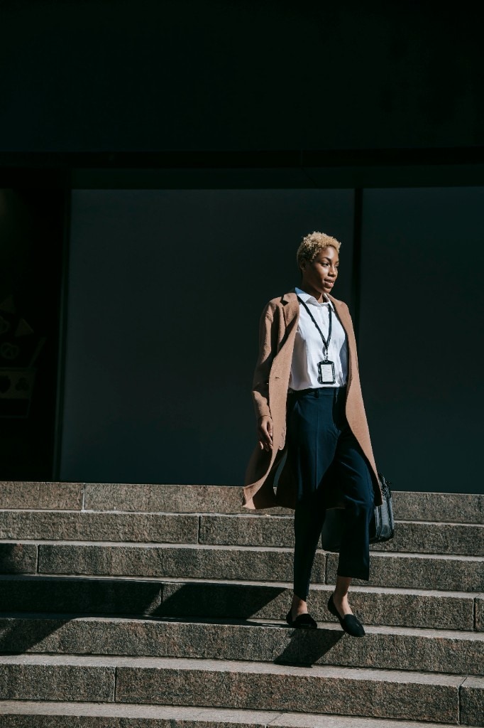 Professional woman descending city steps with purpose
