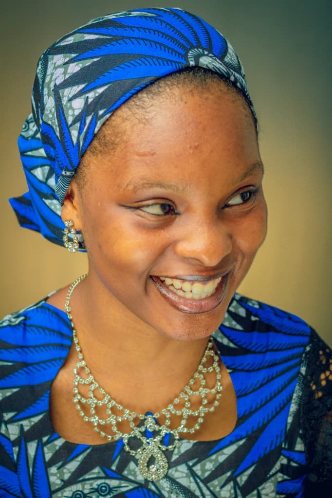 Woman in blue gele with elegant jewelry